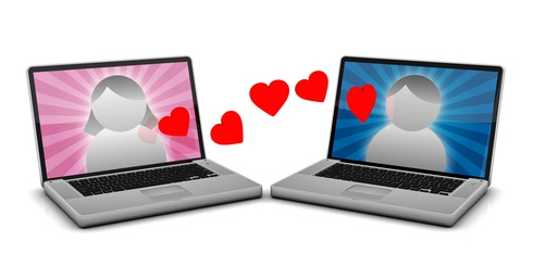 2 Laptops with male and female avatars and hearts floating between them